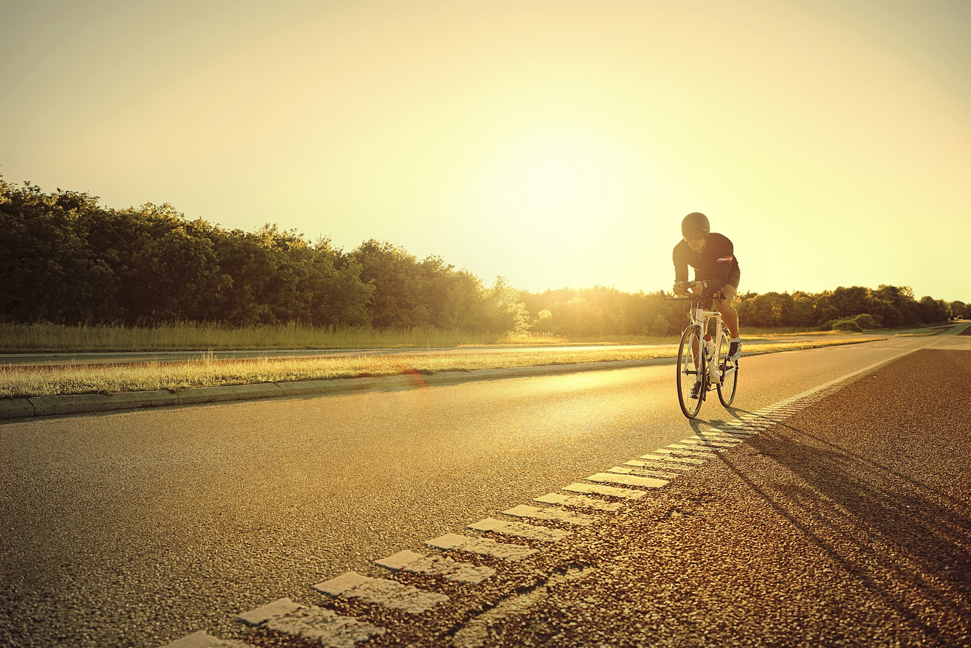 Person on racing bike alone on highway